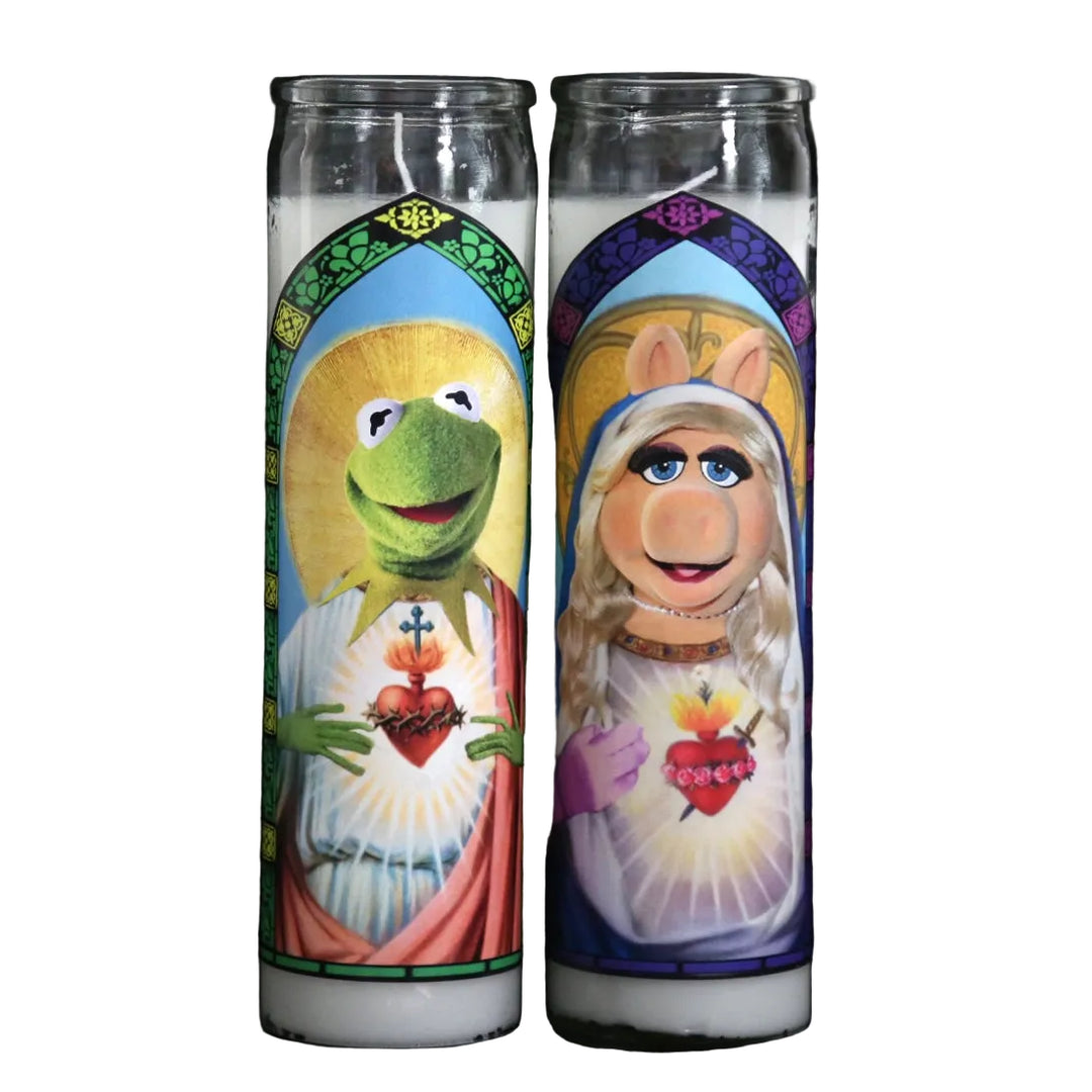 Two prayer candles featuring Kermit the Frog and Miss Piggy from The Muppets on a black background.